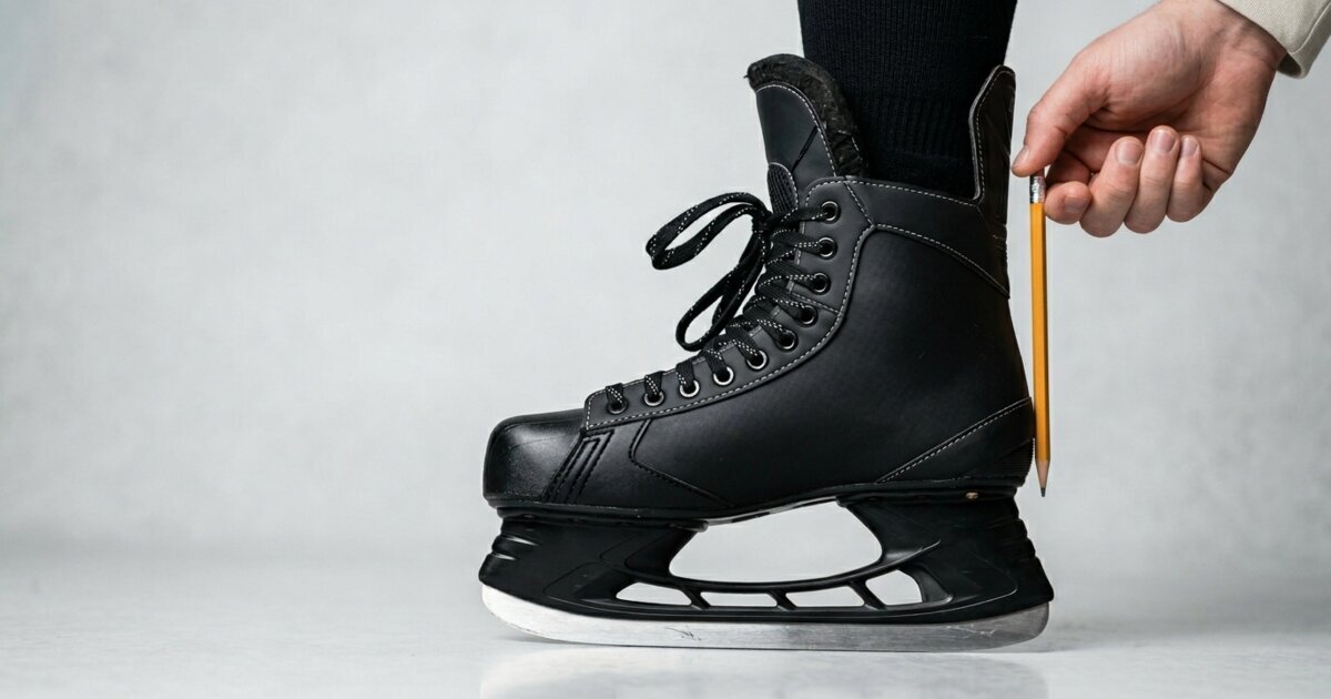 pencil test on a black hockey skate, with a person sliding a pencil into the gap behind the heel to check if the boot is too big